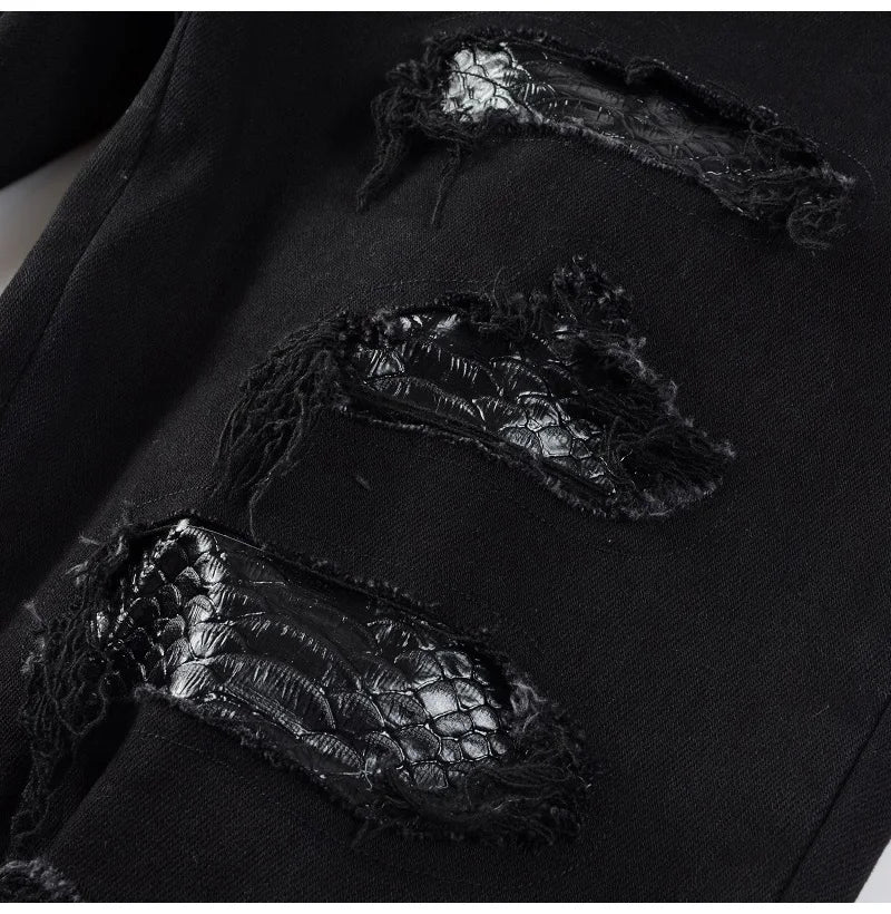Detailed leg view of Nofacebaby Snake Jeans highlighting the textured snake pattern amidst ripped denim for a rugged look.