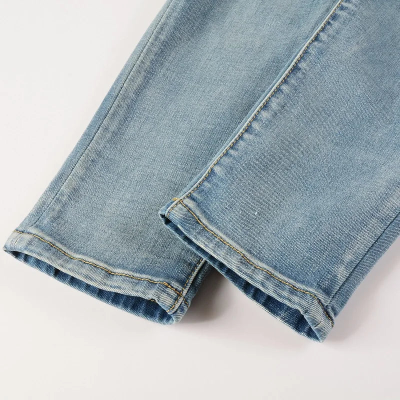 Close-up of K11 Jeans with purple rhinestones peeking through rips.