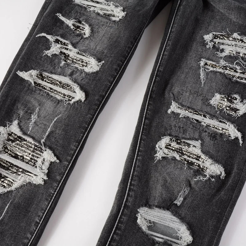 Close-up of the Nofacebaby Grey Skinny Jeans showcasing detailed rips and distressed embellishments for an edgy style.