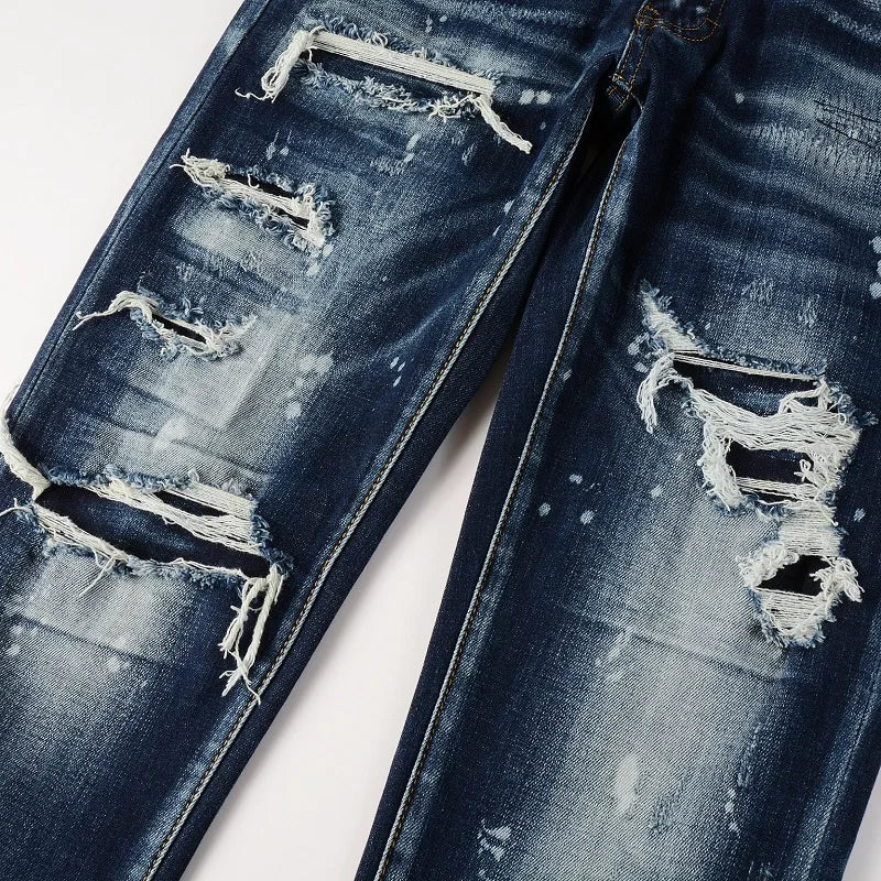 Zoomed-in view of Nofacebaby M13 jeans showing ripped detail with frayed edges.