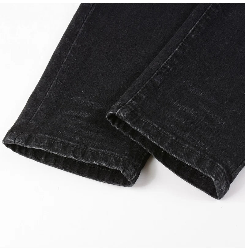 Hem detail of Nofacebaby M31 black jeans showing quality fabric.