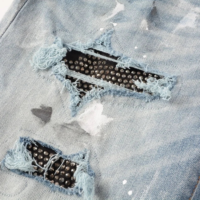 Close-up of black Swarovski crystal details on the ripped sections of Nofacebaby Vitto jeans.