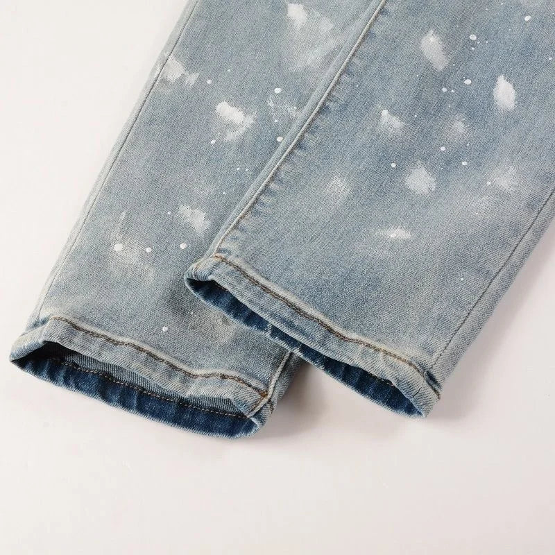 Nofacebaby Vitto jeans featuring unique blue and white paint splatter and Swarovski crystal highlights.