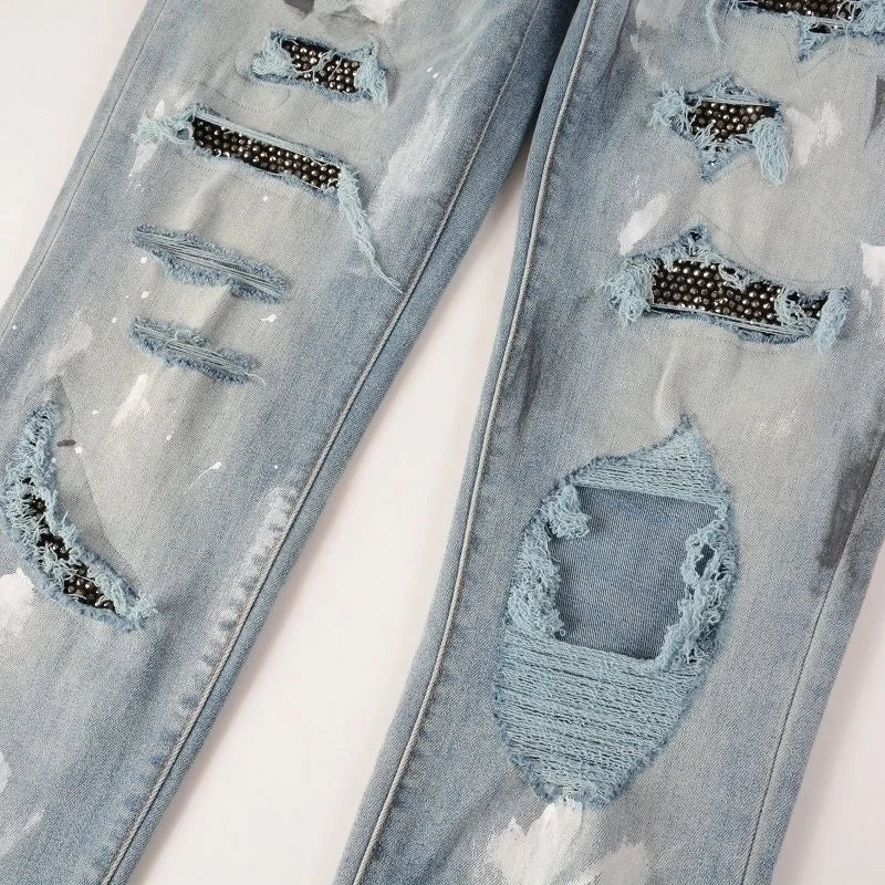 Close-up of black Swarovski crystal details on the ripped sections of Nofacebaby Vitto jeans.