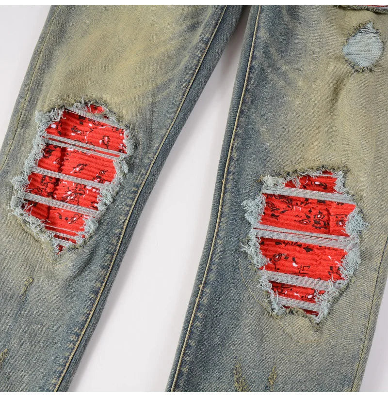 Detailed view of red patched rips on Nofacebaby Ynno Jeans.