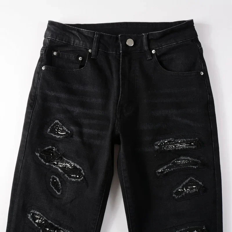Close-up of black Nofacebaby M21 Jeans with sequined rips.